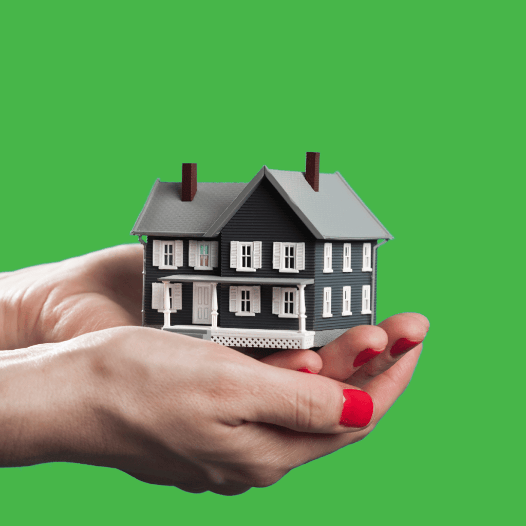 Girl's hand holding a model house of Markon Homes