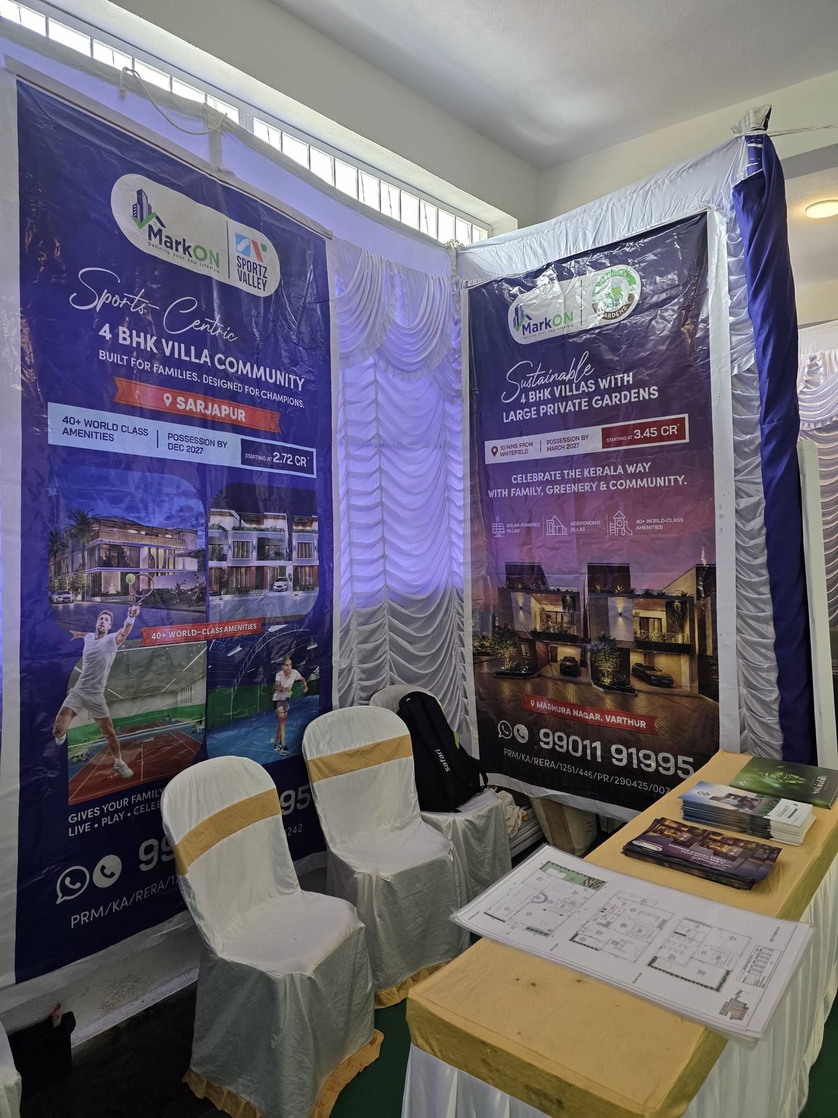 MarkON Homes stall with the Sportz Valley and Madhura Gardens banners