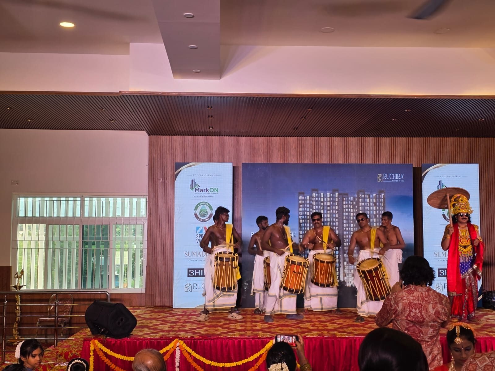 Chenda drummers and a Mahabali character on stage
