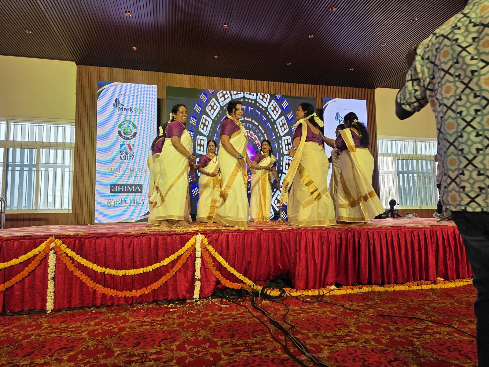 Group dance on stage in traditional kasavu sarees
